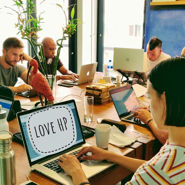 Remote workers in Cape Town, South Africa work on their laptops in the coworking space