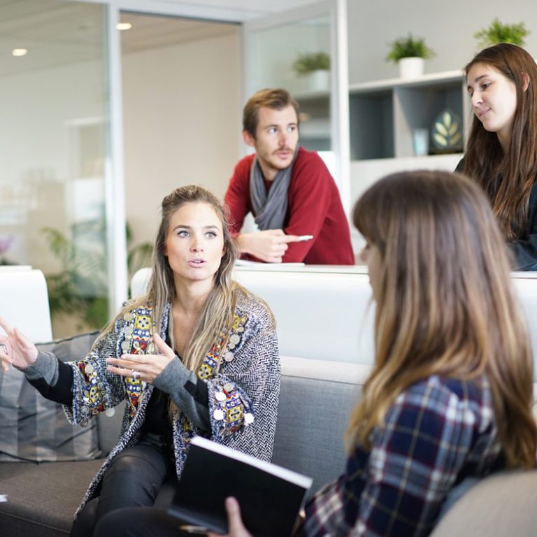 Remote workers discuss side projects at the coworking space