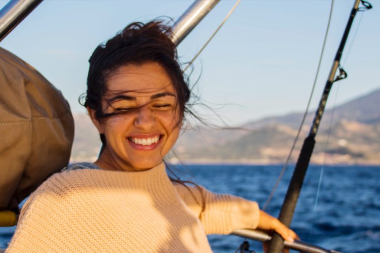 Remote worker on sailboat in Lesbos, Greece on a windy day