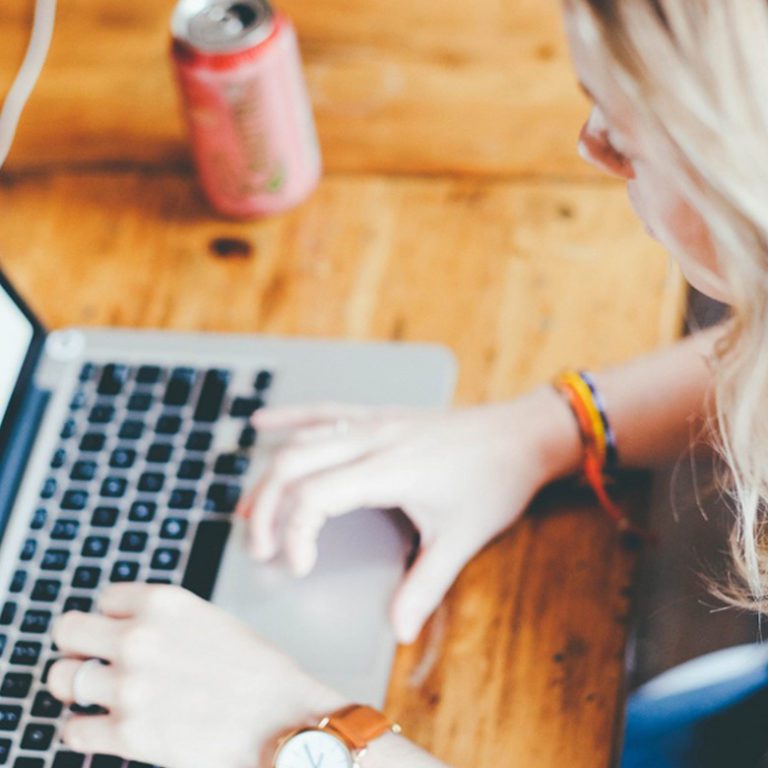 Digital nomad types on laptop in the coworking space