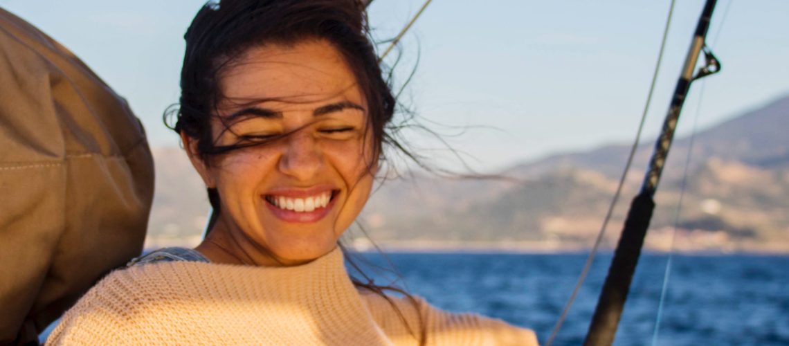 Remote worker on sailboat in Lesbos, Greece on a windy day