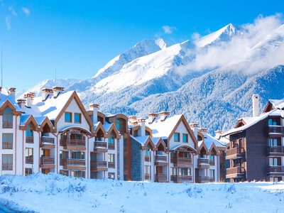 Houses and snow mountains panorama in bulgarian ski resort Bansko Wooden chalet, houses and snow mountains landscape panorama in bulgarian ski resort Bansko, Bulgaria
