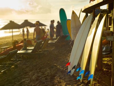 Surfboards for rent on Bali beach at sunset
